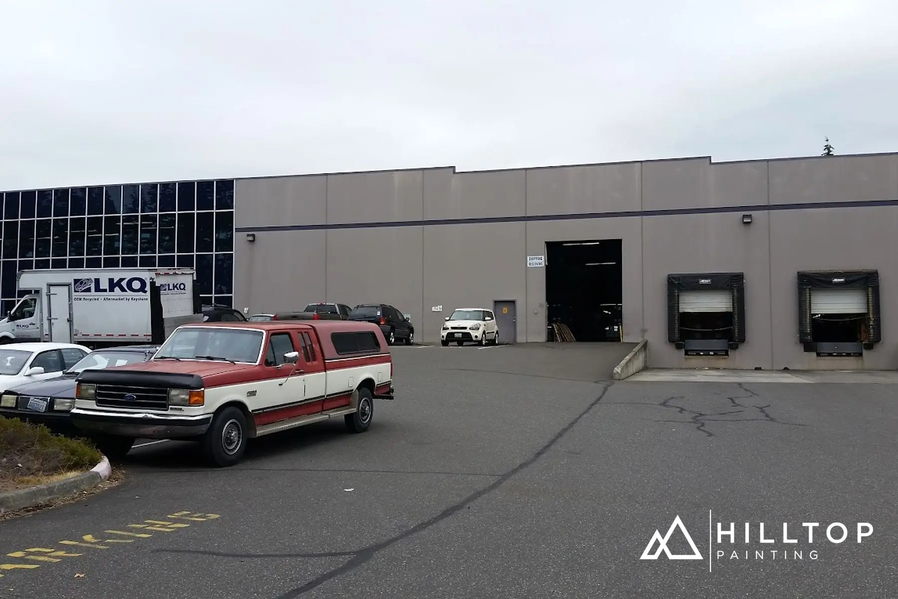 Before: The LKQ Warehouse off Bakerview — a Boom-Lift Repaint in Two Colors