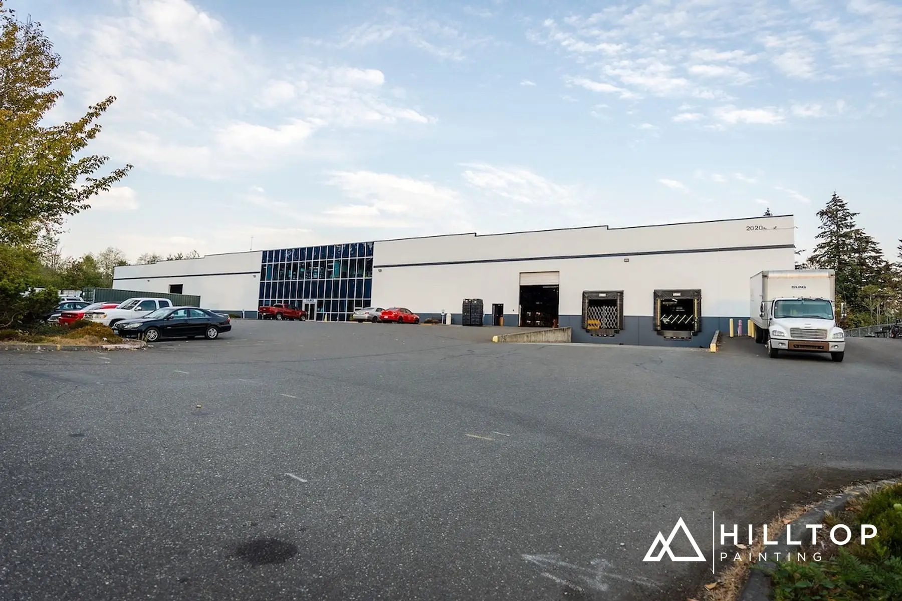 After: The LKQ Warehouse off Bakerview — a Boom-Lift Repaint in Two Colors