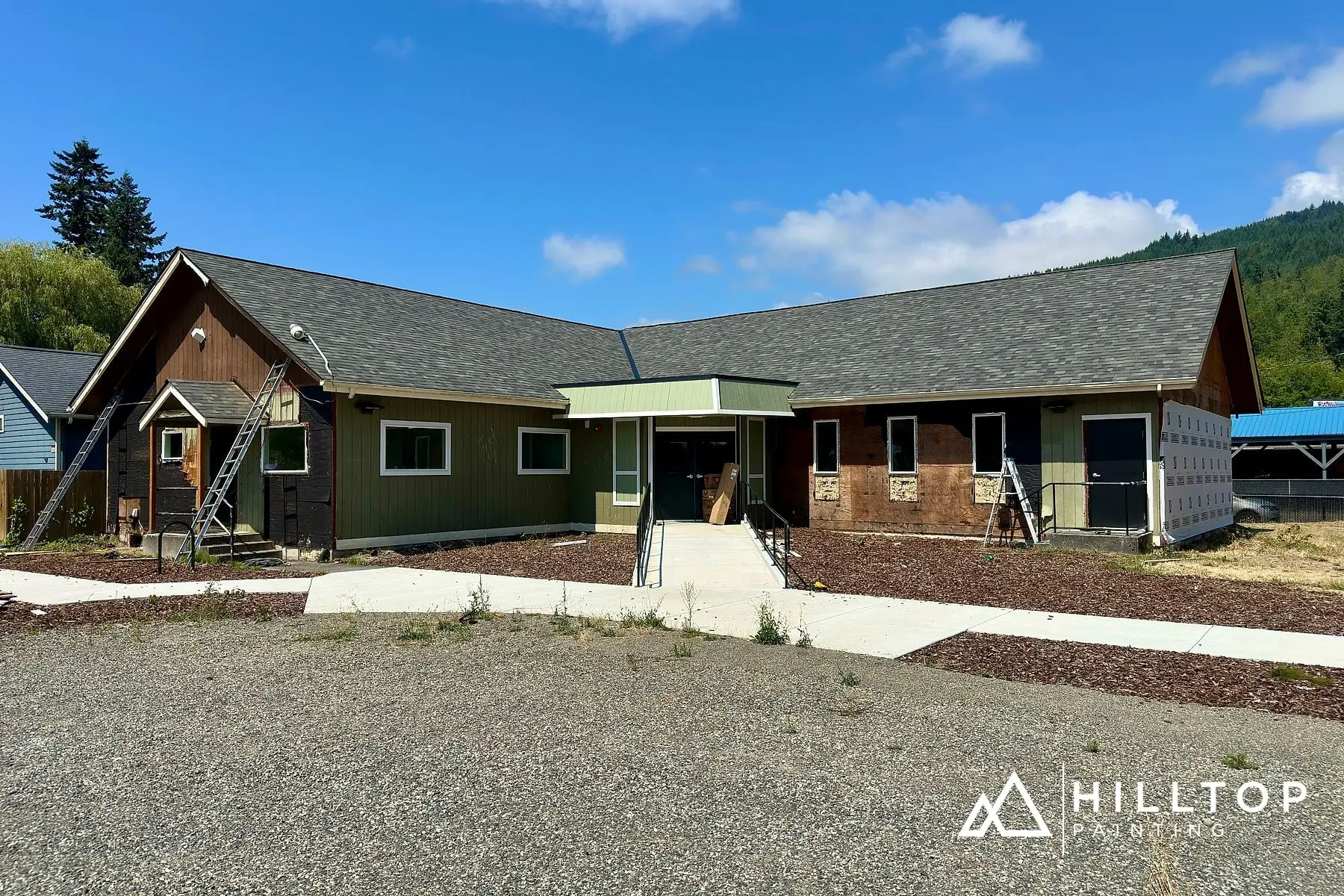 Before: Re-Sided, Repaired & Repainted — a Deming Commercial Building in Sage Green