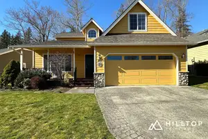 Butter-Yellow Kept Warm — a Bellingham Stone-Front Cottage & Its Garage Doors — Bellingham, WA 98226