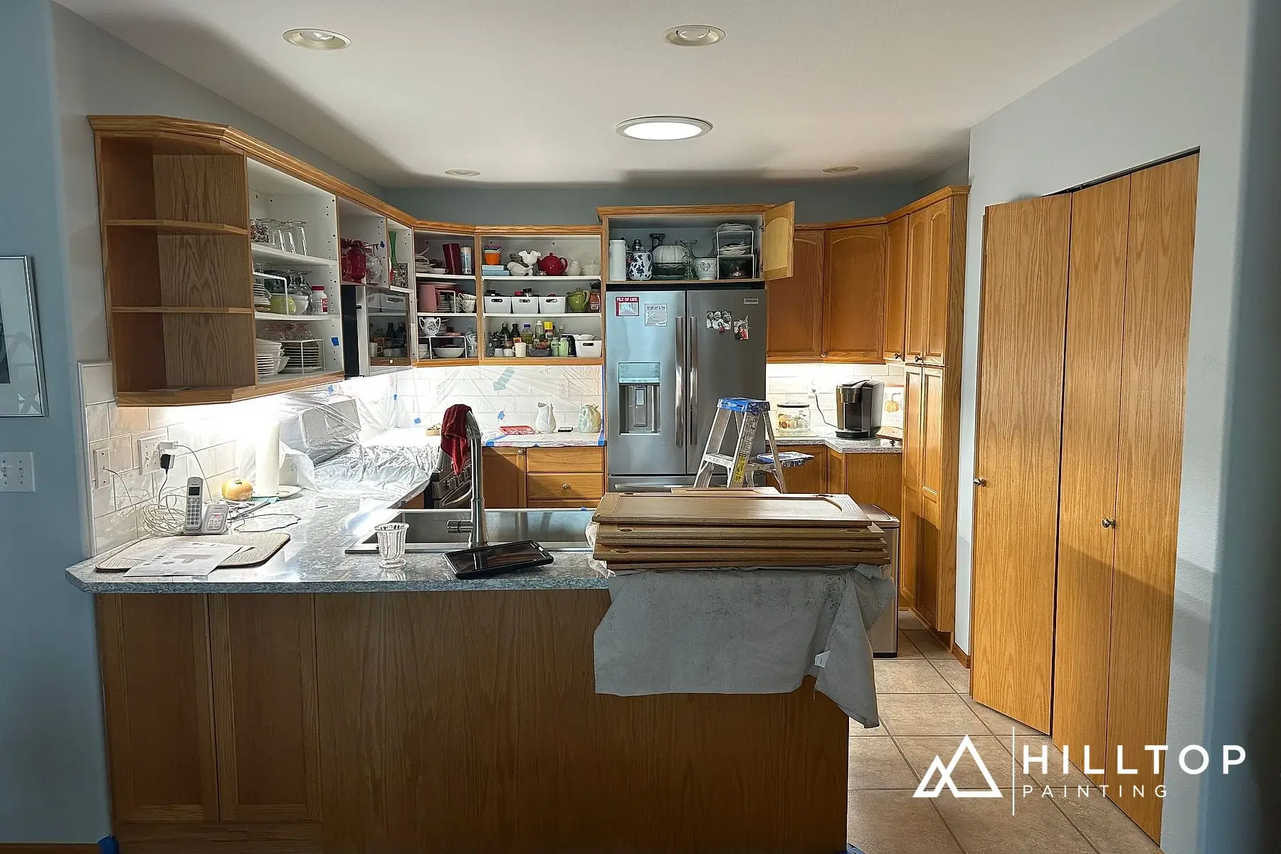 Before: Golden Oak to a Soft Blue-Green — a 35-Door Bellingham Cabinet Repaint